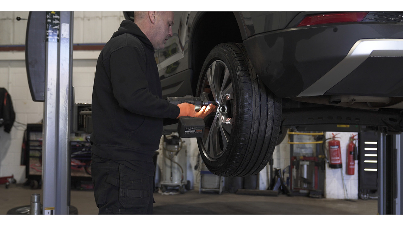 mechanic removing wheel