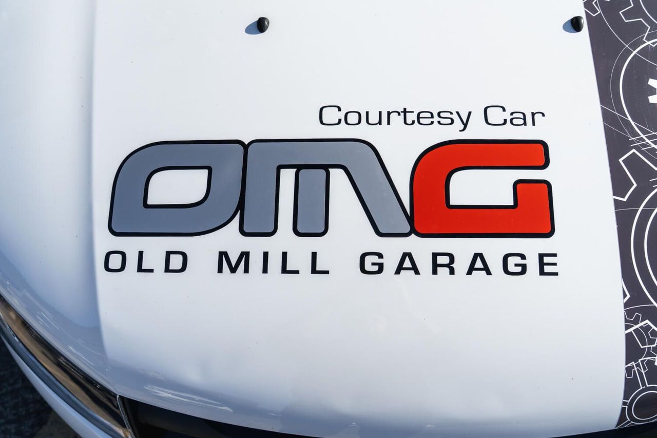 bonnet of Old Mill Garage courtesy car with logo and name on