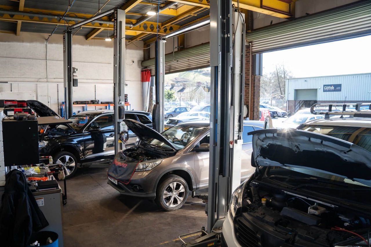 car garage with two cars being worked on