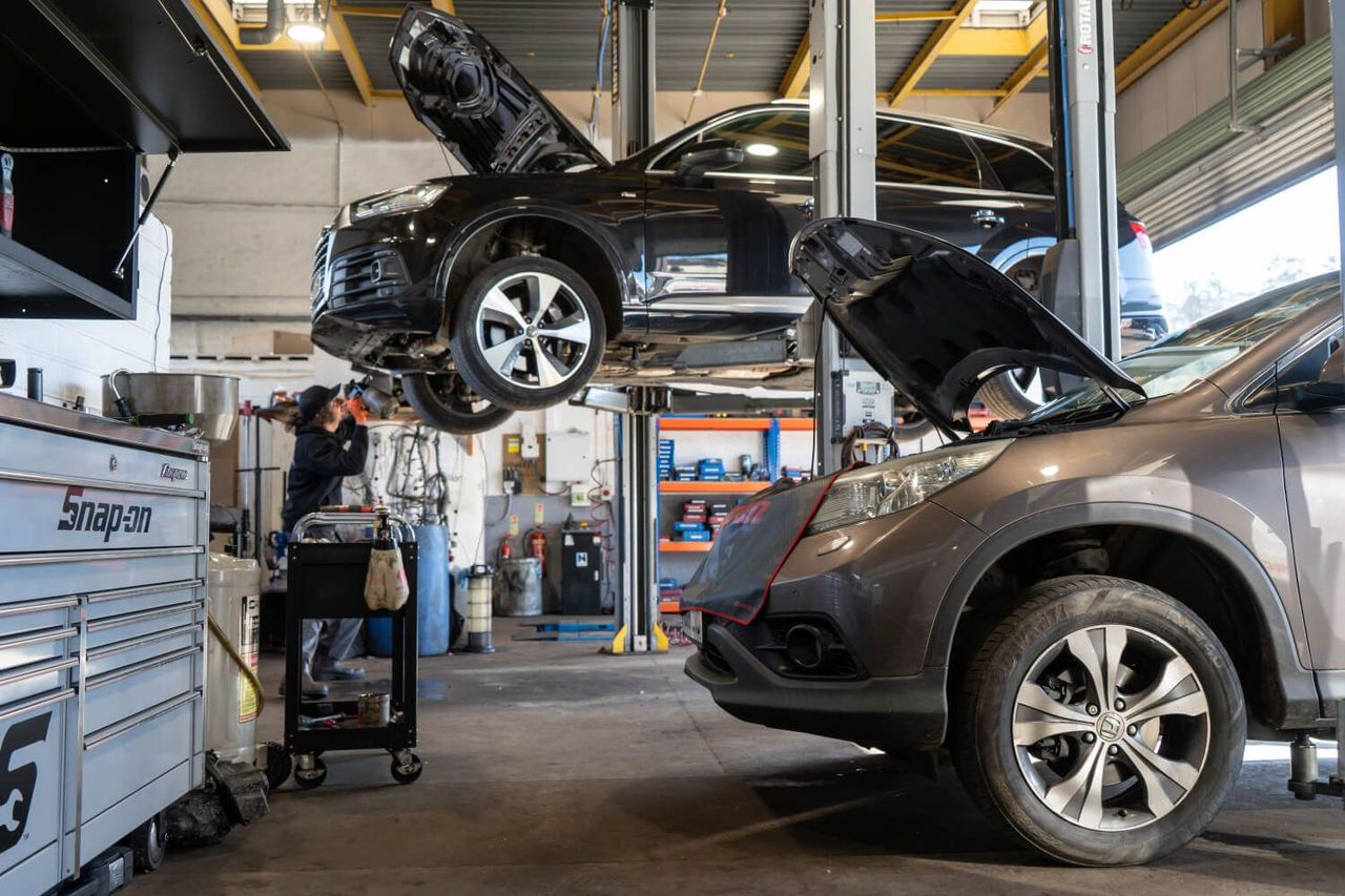 cars in garage one up on lift