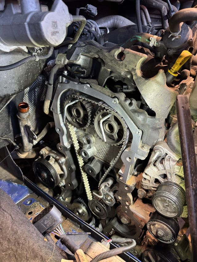 car engine open with wet belt showing