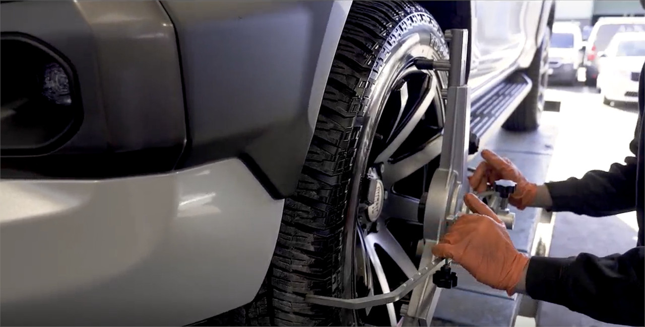 wheel alignment tool on wheel to correct